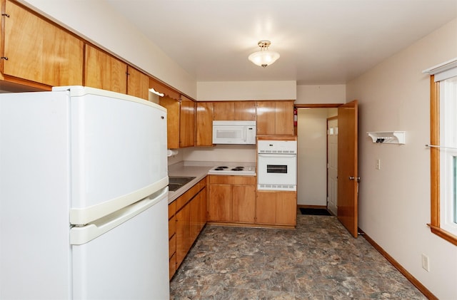 1022 Trisha Ave, Des Moines, IA 50313 - kitchen with white appliances, stone finish flooring, and light countertops