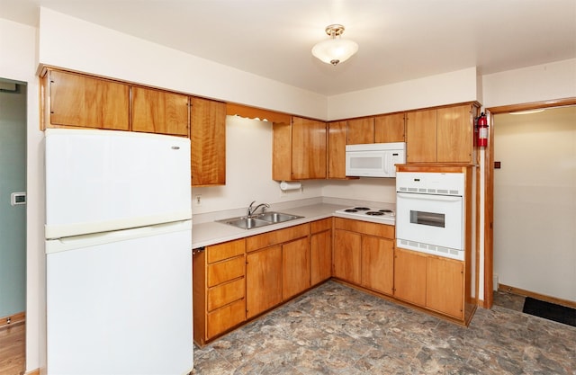 1022 Trisha Ave, Des Moines, IA 50313 - kitchen with white appliances, light countertops, stone finish floors, and brown cabinetry