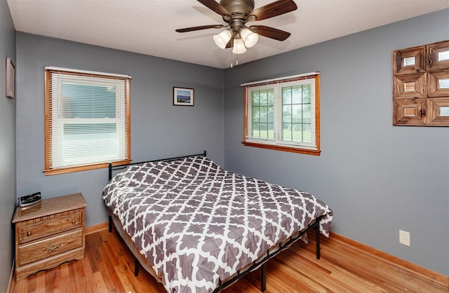 1022 Trisha Ave, Des Moines, IA 50313 - bedroom featuring wood finished floors and a ceiling fan