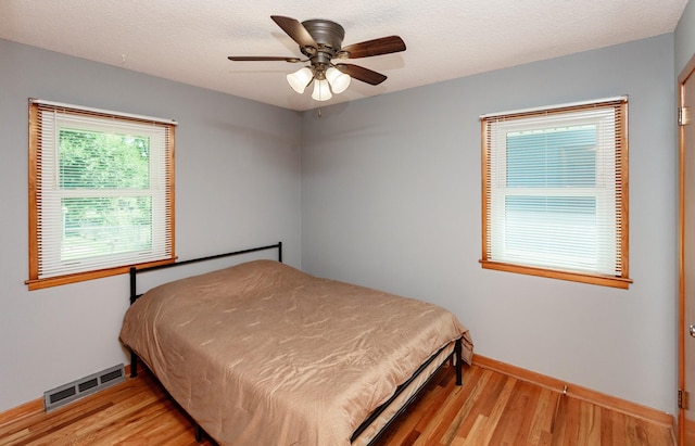 1022 Trisha Ave, Des Moines, IA 50313 - bedroom with light wood-style flooring and a ceiling fan
