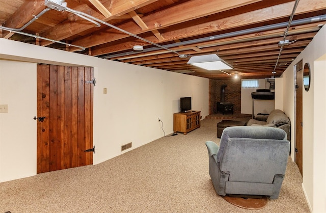 1022 Trisha Ave, Des Moines, IA 50313 - finished below grade area with a wood stove and carpet
