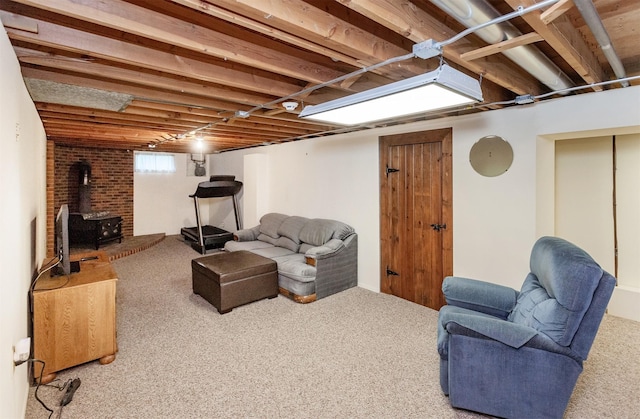 1022 Trisha Ave, Des Moines, IA 50313 - living room with a wood stove and carpet flooring