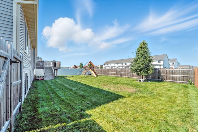716 James St NE, Bondurant, IA 50035 - fenced backyard with stairway, a playground, a residential view, and a wooden deck