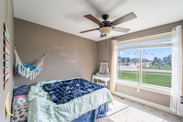 716 James St NE, Bondurant, IA 50035 - carpeted bedroom with baseboards and ceiling fan