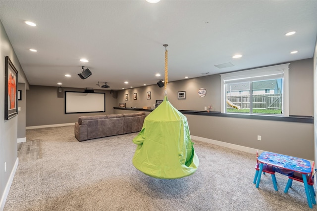716 James St NE, Bondurant, IA 50035 - carpeted home theater room featuring recessed lighting