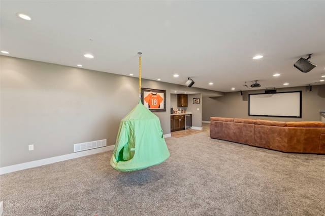 716 James St NE, Bondurant, IA 50035 - home theater with light carpet, bar, and recessed lighting