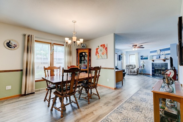 201 E 1st St, Woodward, IA 50276 - dining space with plenty of natural light, a chandelier, light wood-type flooring, and ceiling fan