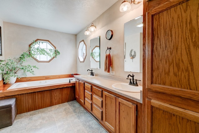 201 E 1st St, Woodward, IA 50276 - full bath with double vanity, a garden tub, and a textured ceiling