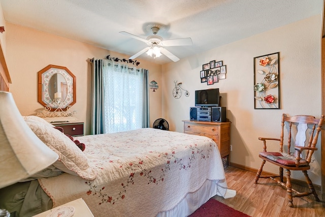 201 E 1st St, Woodward, IA 50276 - bedroom with light wood-type flooring and ceiling fan