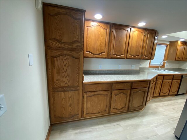2615 59th St, Des Moines, IA 50322 - kitchen featuring brown cabinets, light wood-type flooring, light countertops, dishwasher, and recessed lighting