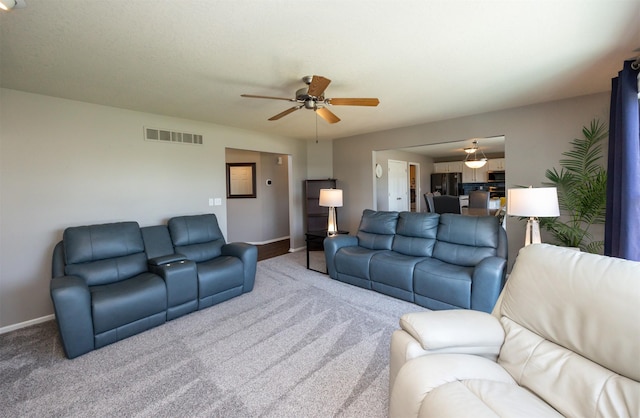 4104 SW 2nd St, Ankeny, IA 50023 - carpeted living room featuring a ceiling fan and baseboards