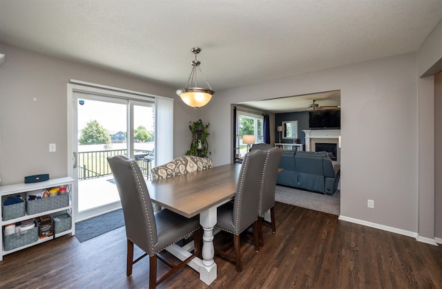 4104 SW 2nd St, Ankeny, IA 50023 - dining area featuring dark wood-style floors, a fireplace, and a ceiling fan