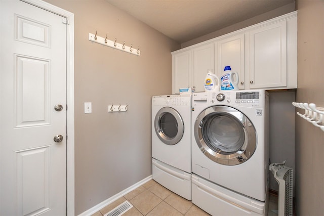 4104 SW 2nd St, Ankeny, IA 50023 - laundry room featuring cabinet space, washer and dryer, and light tile patterned floors