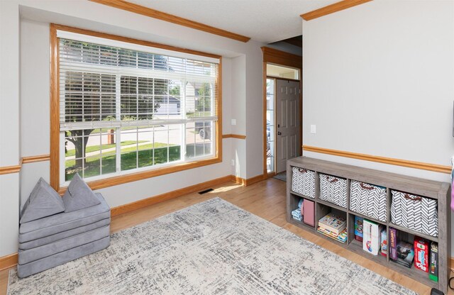 705 Patterson Dr, Carlisle, IA 50047 - living area with wood finished floors and crown molding