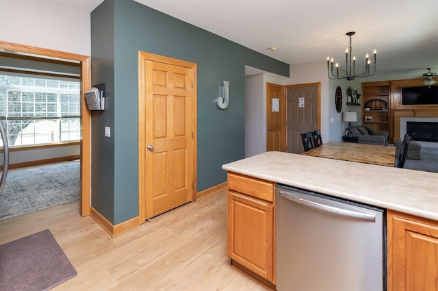 705 Patterson Dr, Carlisle, IA 50047 - kitchen with stainless steel dishwasher, light wood-type flooring, open floor plan, light countertops, and a chandelier