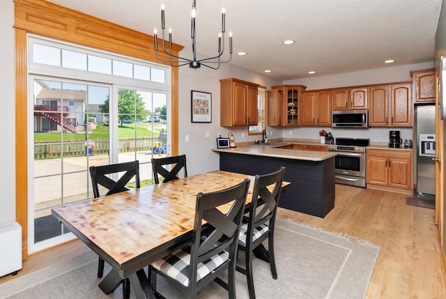 705 Patterson Dr, Carlisle, IA 50047 - dining area featuring a chandelier, light wood-type flooring, recessed lighting, and a textured ceiling