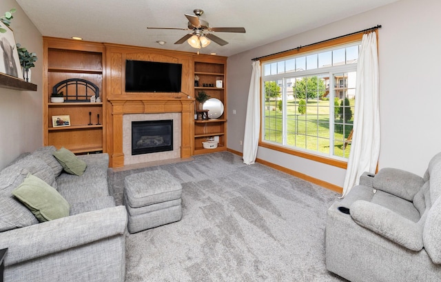 705 Patterson Dr, Carlisle, IA 50047 - carpeted living area with a ceiling fan, a tile fireplace, and built in features
