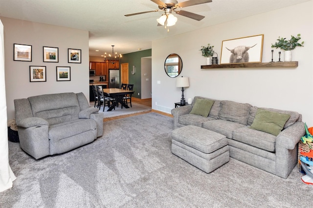 705 Patterson Dr, Carlisle, IA 50047 - living room with a chandelier, ceiling fan, and light carpet
