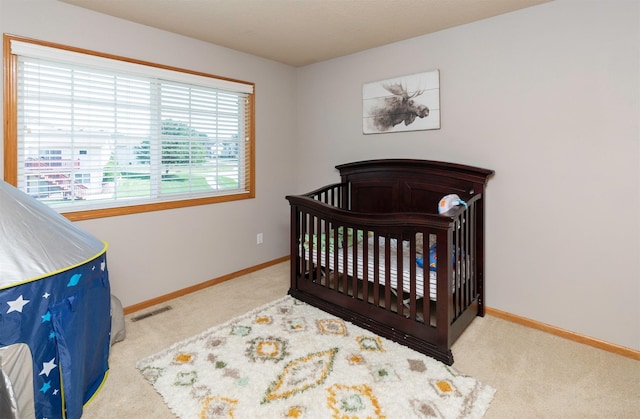 705 Patterson Dr, Carlisle, IA 50047 - bedroom featuring carpet flooring and a crib