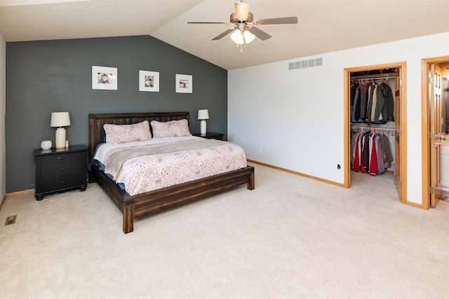 705 Patterson Dr, Carlisle, IA 50047 - bedroom with light colored carpet, a spacious closet, a closet, vaulted ceiling, and a ceiling fan