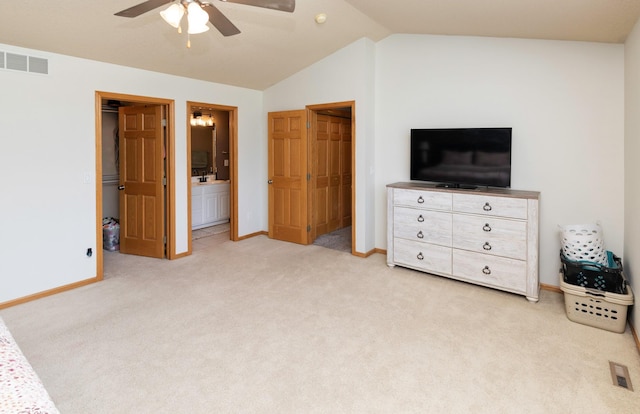 705 Patterson Dr, Carlisle, IA 50047 - bedroom featuring light colored carpet, vaulted ceiling, connected bathroom, a spacious closet, and a ceiling fan