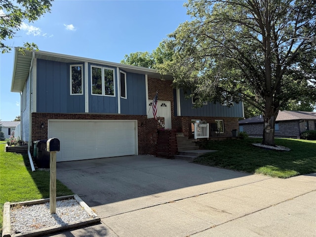 410 N 6th St, Winterset, IA 50273 - split foyer home featuring brick siding, a front yard, an attached garage, and concrete driveway