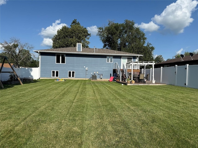 410 N 6th St, Winterset, IA 50273 - rear view of house featuring a fenced backyard and a patio area