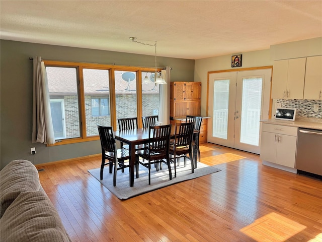 410 N 6th St, Winterset, IA 50273 - dining room featuring healthy amount of natural light, light wood finished floors, and french doors