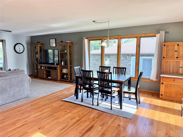 410 N 6th St, Winterset, IA 50273 - dining space with a chandelier and light wood-style flooring