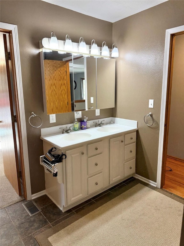 410 N 6th St, Winterset, IA 50273 - bathroom featuring double vanity and baseboards