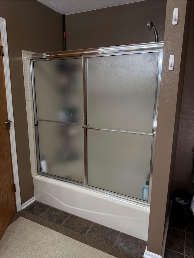 410 N 6th St, Winterset, IA 50273 - bathroom featuring enclosed tub / shower combo and tile patterned floors