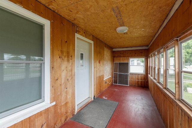 1442 Lucas Ave, Chariton, IA 50049 - unfurnished sunroom with wood walls and wood finished floors