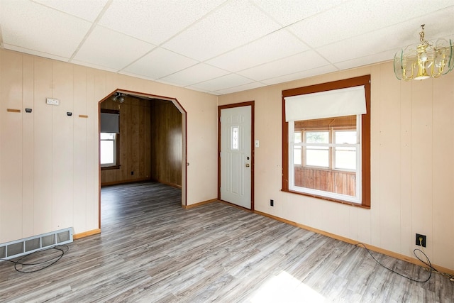 1442 Lucas Ave, Chariton, IA 50049 - foyer entrance with wood finished floors, arched walkways, a drop ceiling, and a chandelier