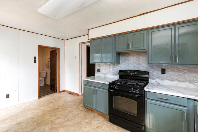 1442 Lucas Ave, Chariton, IA 50049 - kitchen featuring black range with gas stovetop, tasteful backsplash, and light stone counters