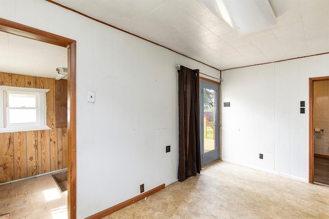 1442 Lucas Ave, Chariton, IA 50049 - empty room featuring healthy amount of natural light and wooden walls