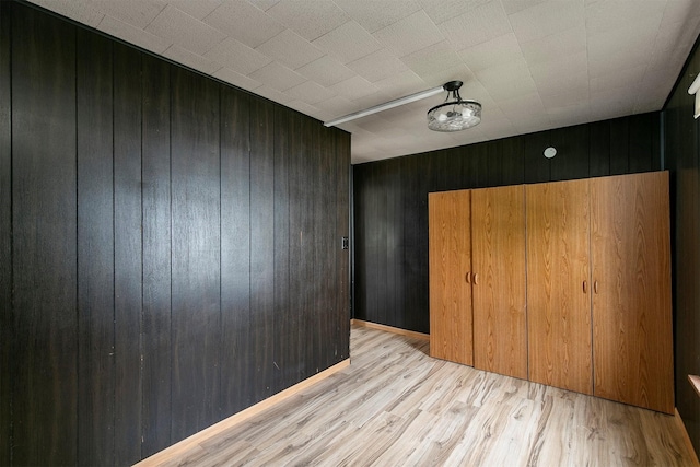 1442 Lucas Ave, Chariton, IA 50049 - unfurnished bedroom featuring wooden walls and wood finished floors