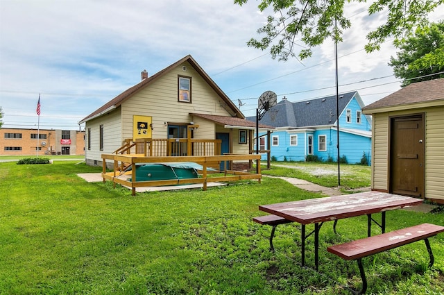1442 Lucas Ave, Chariton, IA 50049 - rear view of property with a lawn, a chimney, and a wooden deck