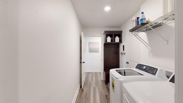 5453 Rowling Dr, Ames, IA 50014 - laundry room with separate washer and dryer, light wood-type flooring, and recessed lighting