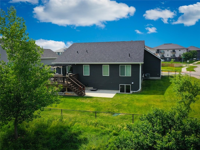 5453 Rowling Dr, Ames, IA 50014 - rear view of house with a fenced backyard, a deck, a patio area, and stairs