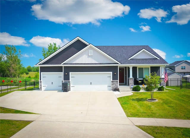 5453 Rowling Dr, Ames, IA 50014 - craftsman house featuring a porch, an attached garage, concrete driveway, roof with shingles, and board and batten siding