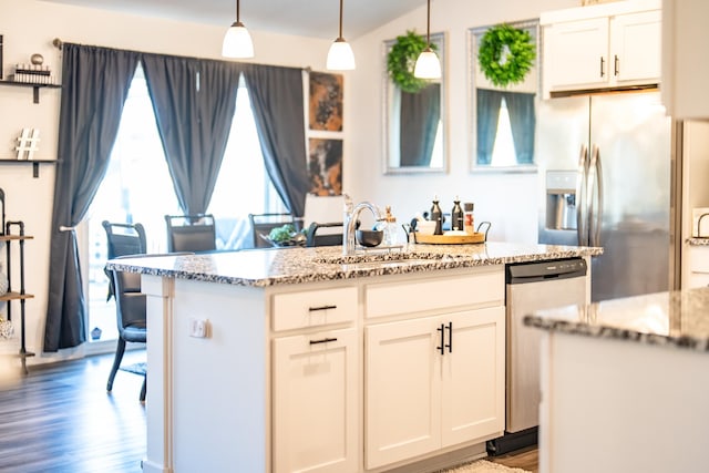 5453 Rowling Dr, Ames, IA 50014 - kitchen featuring stainless steel appliances, light stone countertops, white cabinets, wood finished floors, and hanging light fixtures