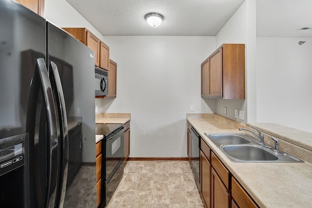 10320 Norfolk Dr Unit 7, Johnston, IA 50131 - kitchen with black appliances, brown cabinetry, light countertops, and stone finish flooring