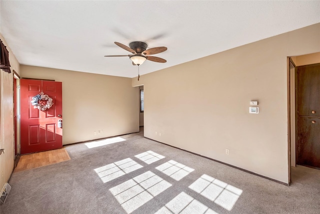 3520 E 32nd St, Des Moines, IA 50317 - empty room with light colored carpet and a ceiling fan