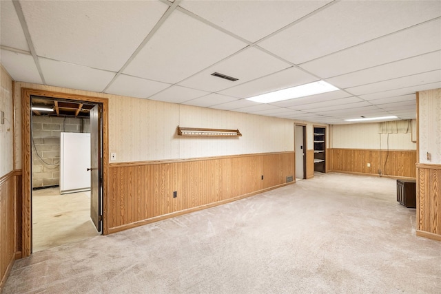 3520 E 32nd St, Des Moines, IA 50317 - finished basement with a drop ceiling, carpet flooring, wainscoting, and wood walls