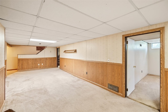 3520 E 32nd St, Des Moines, IA 50317 - basement with carpet floors, wainscoting, wooden walls, and a paneled ceiling