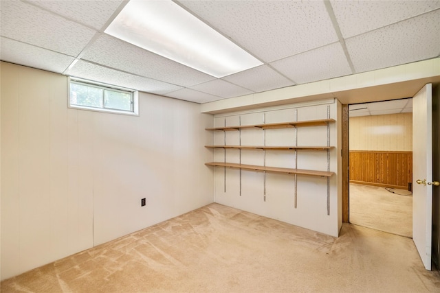 3520 E 32nd St, Des Moines, IA 50317 - below grade area with carpet flooring, wooden walls, and a drop ceiling