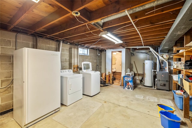 3520 E 32nd St, Des Moines, IA 50317 - basement with water heater, independent washer and dryer, freestanding refrigerator, and heating unit