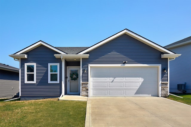 16621 Goodman Dr, Urbandale, IA 50323 - ranch-style house with stone siding, a garage, concrete driveway, and a front yard