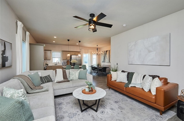 16621 Goodman Dr, Urbandale, IA 50323 - living room with a chandelier, ceiling fan, wood finished floors, and recessed lighting