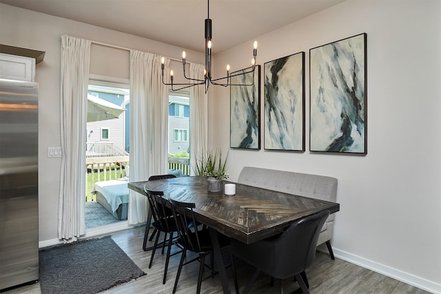 16621 Goodman Dr, Urbandale, IA 50323 - dining room featuring a chandelier and wood finished floors